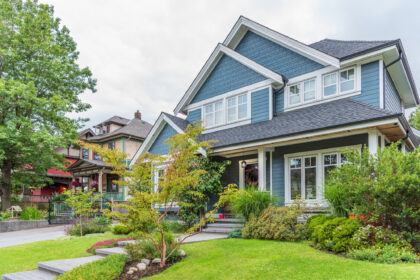 Blue two-story house with landscaping